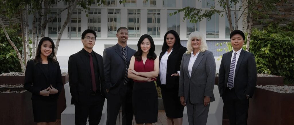 Solution Now Law Firm attorneys and staff standing together outside a building