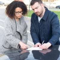Man filling documents after a car accident