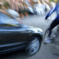 Car about to hit a man in bicycle