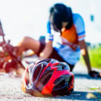 person on the ground after bicycle accident