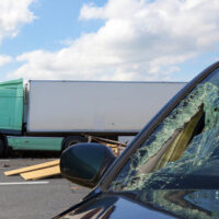 Broken windshield after crashing against a truck