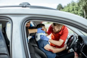 Emergency responders assisting a victim with neck and back injuries at the scene of a San Jose car accident, showcasing the importance of prompt medical attention after a crash.