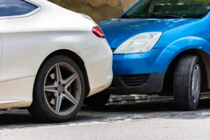 Two cars involved in a minor collision in a parking lot, illustrating common parking lot accidents and the need for legal assistance.