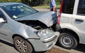 Rear-end car accident with significant front-end damage to the silver car, illustrating common injuries from rear-end crashes and the importance of legal representation.
