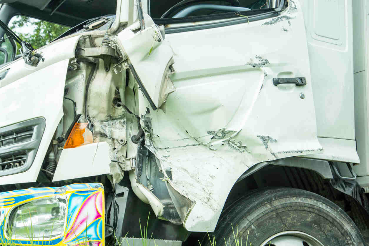Heavily damaged white truck after a collision, for a Fremont truck accident lawyer.