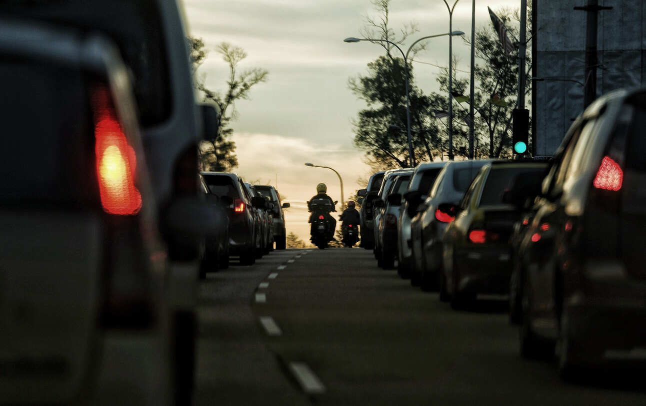 Motorcyclist in congested traffic, illustrating San Jose motorcycle traffic laws and lane splitting.